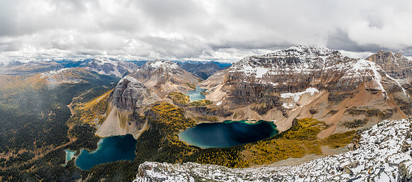 The snow squall is literally just blowing away at left as I summit. Egypt, Mummy and Scarab Lakes along with a million larches contribute to my camera overheating.