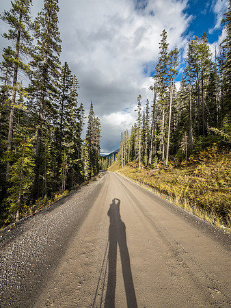 The shadows grow long as I trudge down the final stretch of road to the Sunshine Ski Resort parking lot.