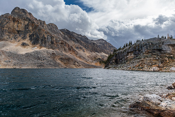 Wild views back past the treed buttress (R) to the unnamed peak over Mummy Lake.