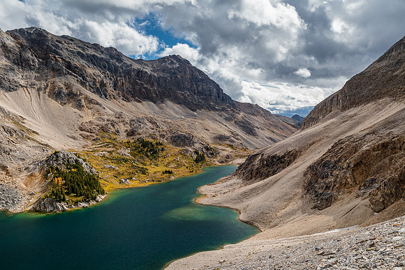 Descending back to the treed buttress with gorgeous views over Mummy Lake.