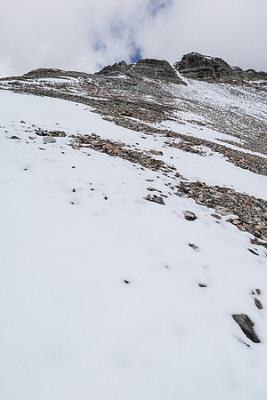 The summit is still a few hundred vertical meters from the col.