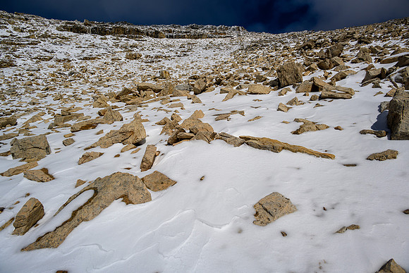 Ascending SW snow and rubble slopes to the summit.