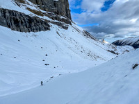 Hiking on snow beneath the west ridge leading up to the summit.