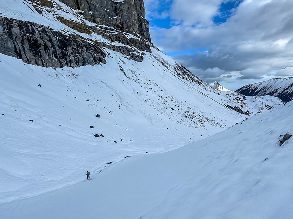 Hiking on snow beneath the west ridge leading up to the summit.