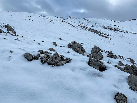 Looking up the very foreshortened and very snowy (!!) west ridge to the summit.