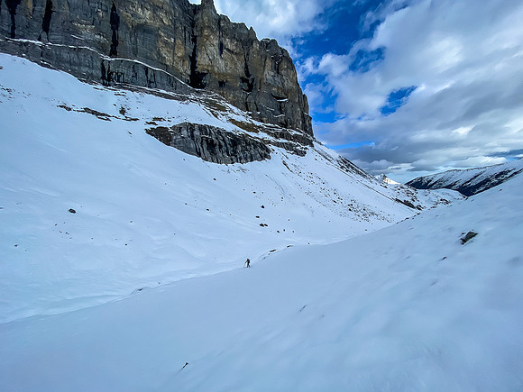Hiking on snow beneath the west ridge leading up to the summit.