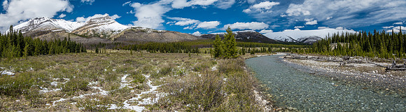 The Ram River runs past alpine meadows which house the South Ram Patrol Cabin (L).