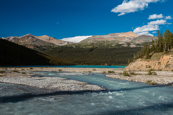 The melting glacier water meets the deeper lake with Num-ti-jah lodge in the distance.