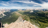 Phil comes up to the summit with an amazing panorama opening up behind him.