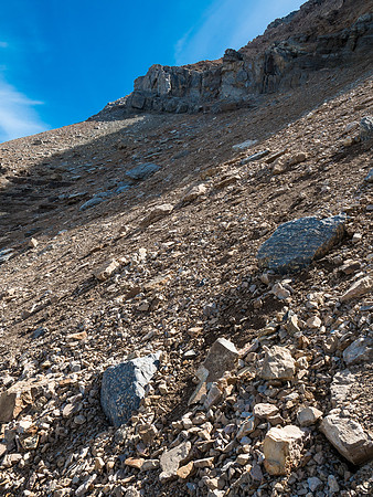 Looking up at the terrain as it curves towards the north end of the summit ridge - the break through the cliffs is obvious at upper left.