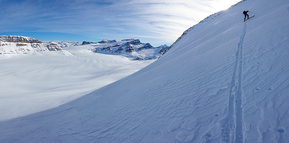 Skiing up the steep NE access slope to the south ridge above.