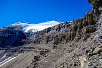 Eric traverses beneath the upper cliff band headed for a notch / couloir that will help us break through it.
