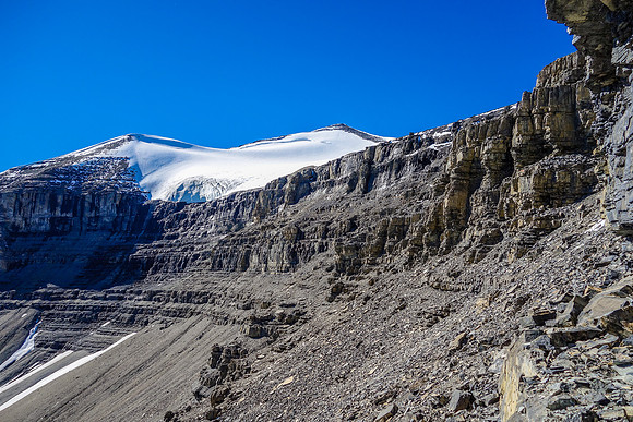 Eric traverses beneath the upper cliff band headed for a notch / couloir that will help us break through it.