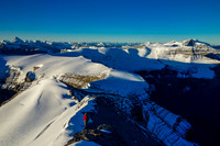 Eric descends the south summit ridge as our long traverse spreads out in front of him and the day dawns clear and calm.