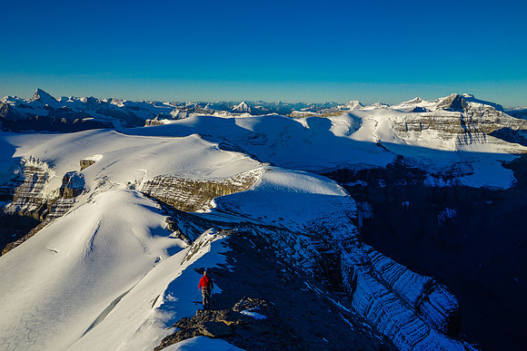 Eric descends the south summit ridge as our long traverse spreads out in front of him and the day dawns clear and calm.