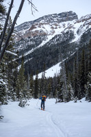 Wietse skis up the Chickadee Valley approach trail. Boom above him.