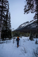 Wietse skis up the Chickadee Valley approach trail. Boom above him.