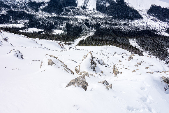 Trudging up the west ridge, looking down at our ascent avy gully far below us now (2nd from right).