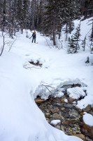 Wietse skis up the Chickadee Valley approach trail. Boom above him.