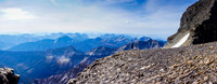 Kev on a shoulder of Lunette Peak underneath it's summit, Assiniboine's SW face rising behind him to the right.