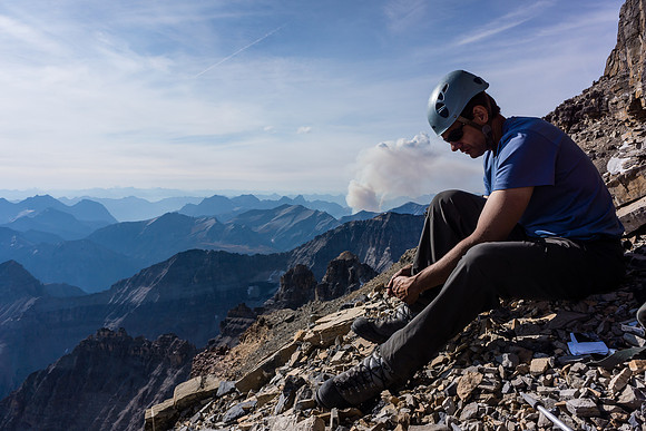 Back at our packs after descending the summit block on Lunette, Kev adjusts his boots for the long and painful descent still ahead of us.