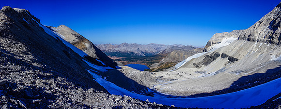 View from the Strom (left) and Assiniboine (right) col looking towards Lake Magog (center). The hut is just left of the lake, obviously much higher on the scree bench.