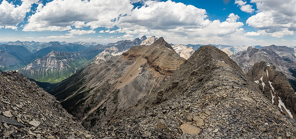Looking back along a shoulder on the ridge below the summit at Alcantara with Eon, Aye and Assiniboine just peeking out now.