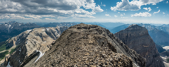 Phil checks out the views from the SW end of the summit block - note the impressive rock wall of the west outlier at right.
