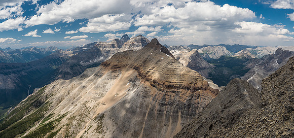 Looking back along a shoulder on the ridge below the summit at Alcantara with Eon, Aye and Assiniboine just peeking out now.