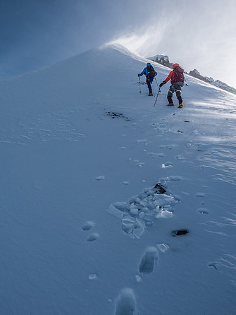 Anton and Mike ascending the end of the snow arete that leads to the final summit slopes (visible at upper right)