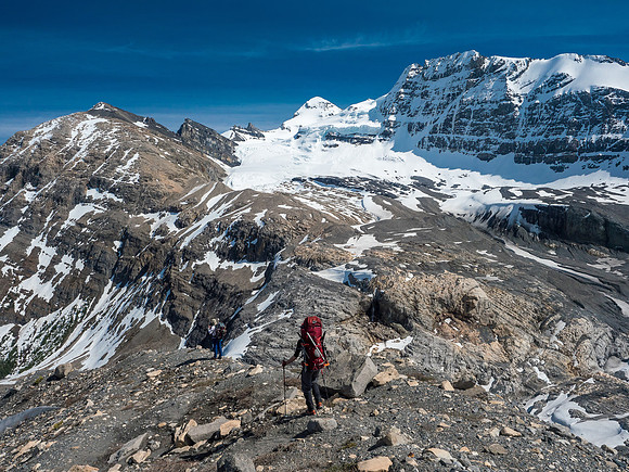 Anton and Mike descend the upper moraine to the top of the headwall bypass route (lower left) as Forbes shows off in the distance.