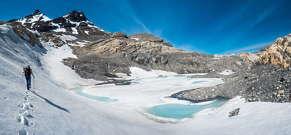 Anton kicks slushy steps around a tarn as we tramp our way from camp, up to the top of the headwall bypass route.