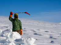 TJ shows just how freaking windy it is - his shovel is blowing level here!