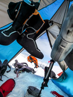 A view from my sleeping matt. We are drying out our ski boot liners and boiling water. Down hut booties are a key piece of equipment out here