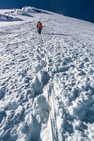 Off the skis and roped up for the SE face snow ascent. It's starting to look big again.