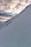 Looking back up and across the rock outcrop, showing the angle of the face as we descend.