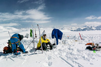 Steven enjoys a break at camp. It's hard to get back on the skis after sitting down in the glorious, warm sunshine!