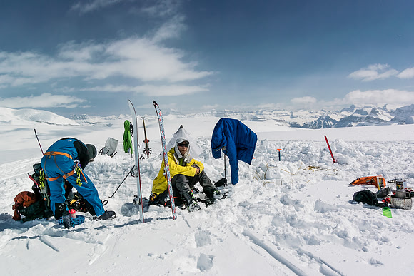 Steven enjoys a break at camp. It's hard to get back on the skis after sitting down in the glorious, warm sunshine!