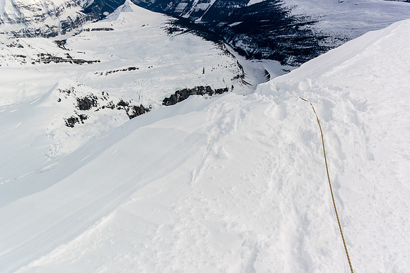 The rope disappears over the edge as I approach the lip of the upper east face.