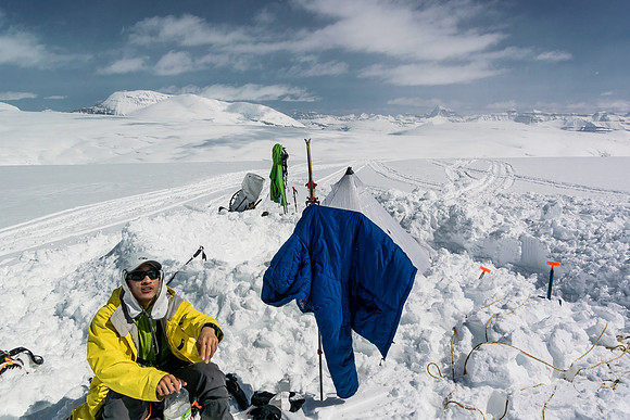 Steven enjoys a break at camp. It's hard to get back on the skis after sitting down in the glorious, warm sunshine!