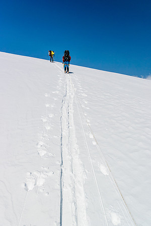 Grunting up the trench with winter camping packs.