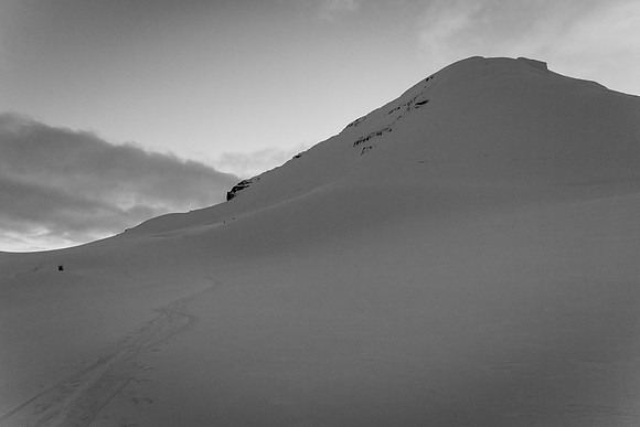 Looking back at Steven and Ben as they ski down from the east face of Columbia in fading light.