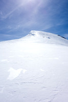 Looking up at the other team as they ditch their skis and prepare for the final ascent on foot. The terrain is much steeper than it appears here.