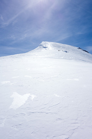 Looking up at the other team as they ditch their skis and prepare for the final ascent on foot. The terrain is much steeper than it appears here.