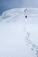 On the right side of the hole, JW is now ready to haul on the 6:1 rescue system he built. On a 40 degree ice slope.