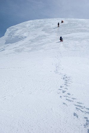 On the right side of the hole, JW is now ready to haul on the 6:1 rescue system he built. On a 40 degree ice slope.