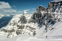 Ben skis down towards West Twin (out of sight to the left) with Twin's Tower looming above.