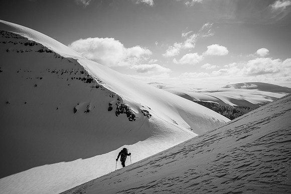 Kev skis up behind me with North Twin's south ridge in the background.