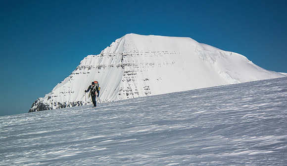 Kev skis from camp with South Twin in the distance.