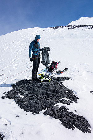 Taking off extra layers - the sun is getting warm now. We put the skis back on soon after this.